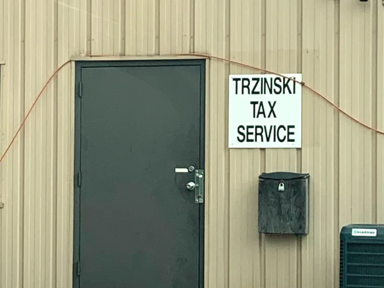 The Trzinski Tax Services building at 2917 Post Rd in Stevens Point, with its TRZINSKI TAX SERVICE sign beside the door.